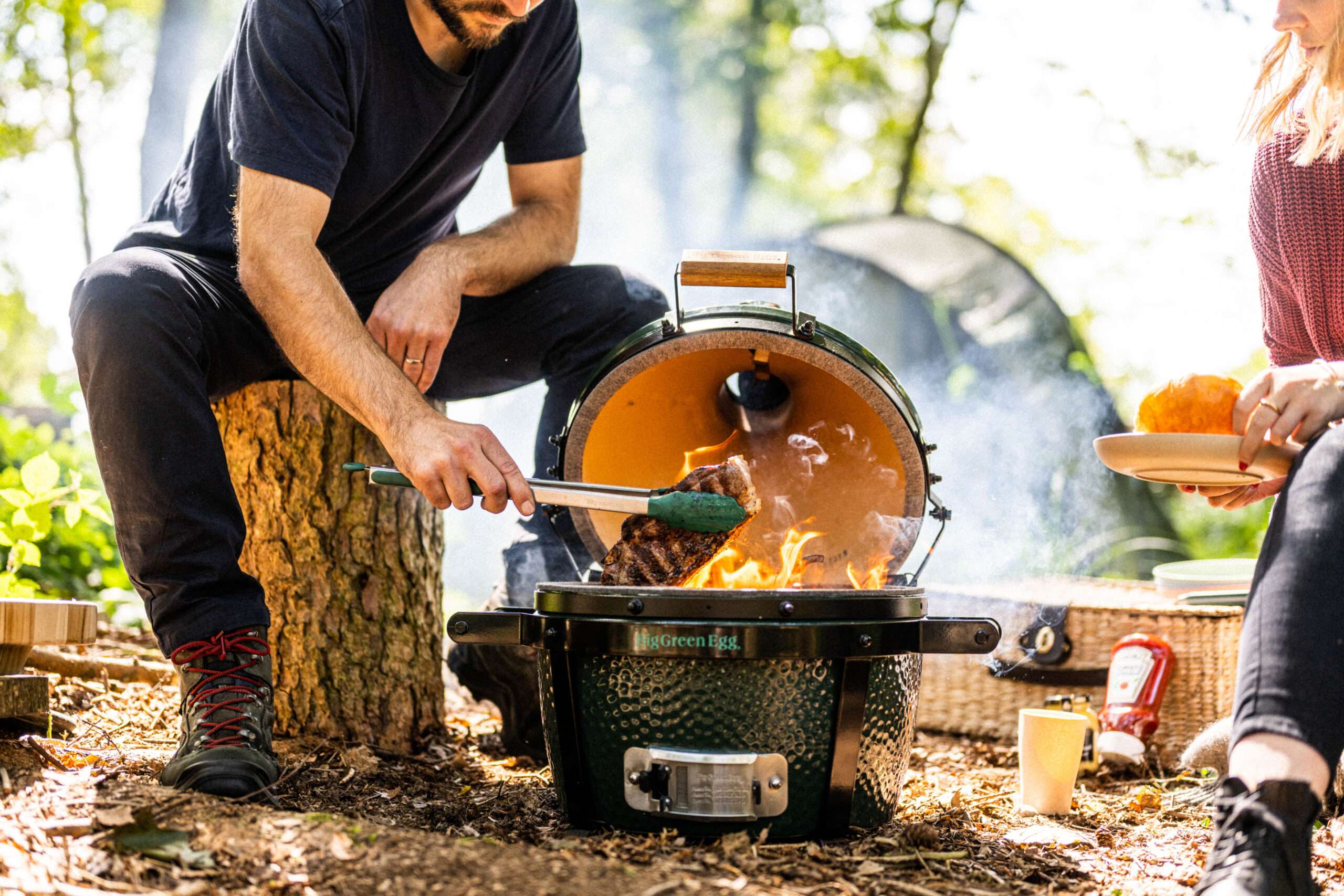 a Big Green Egg BBQ being filled with charcoal