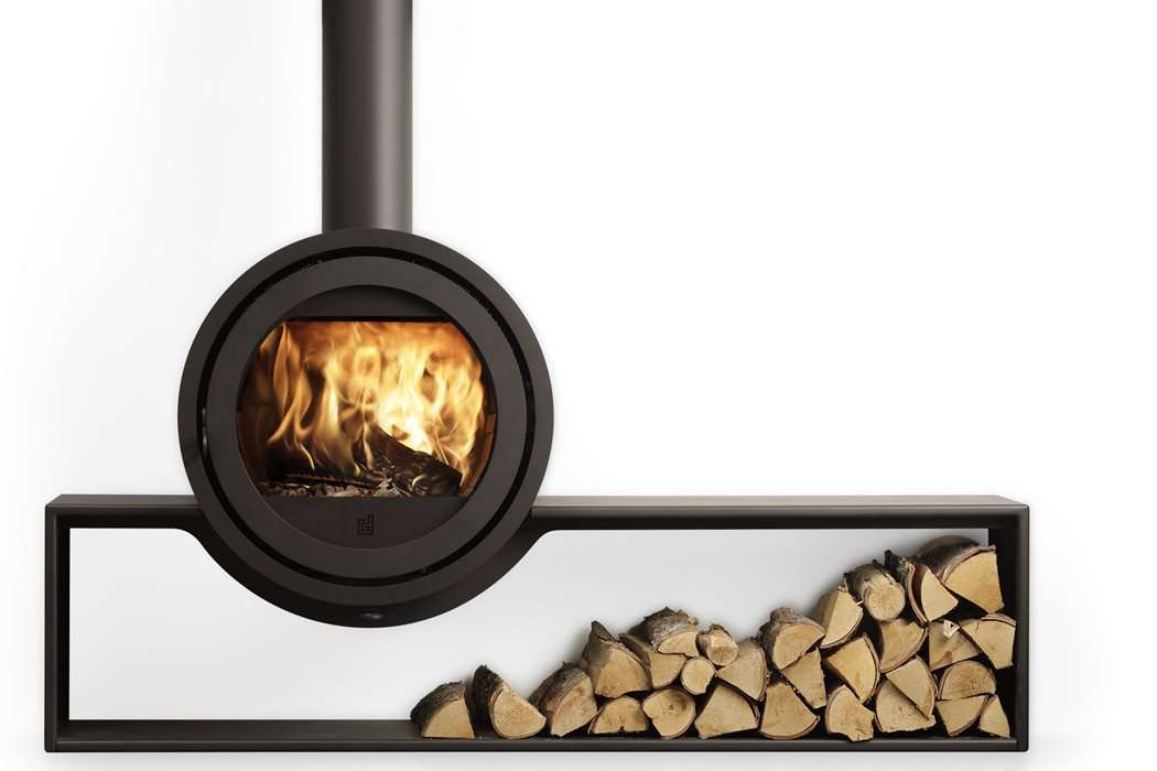 Dik Geurts Odin Tunnel log burner with a stack of firewood beneath.