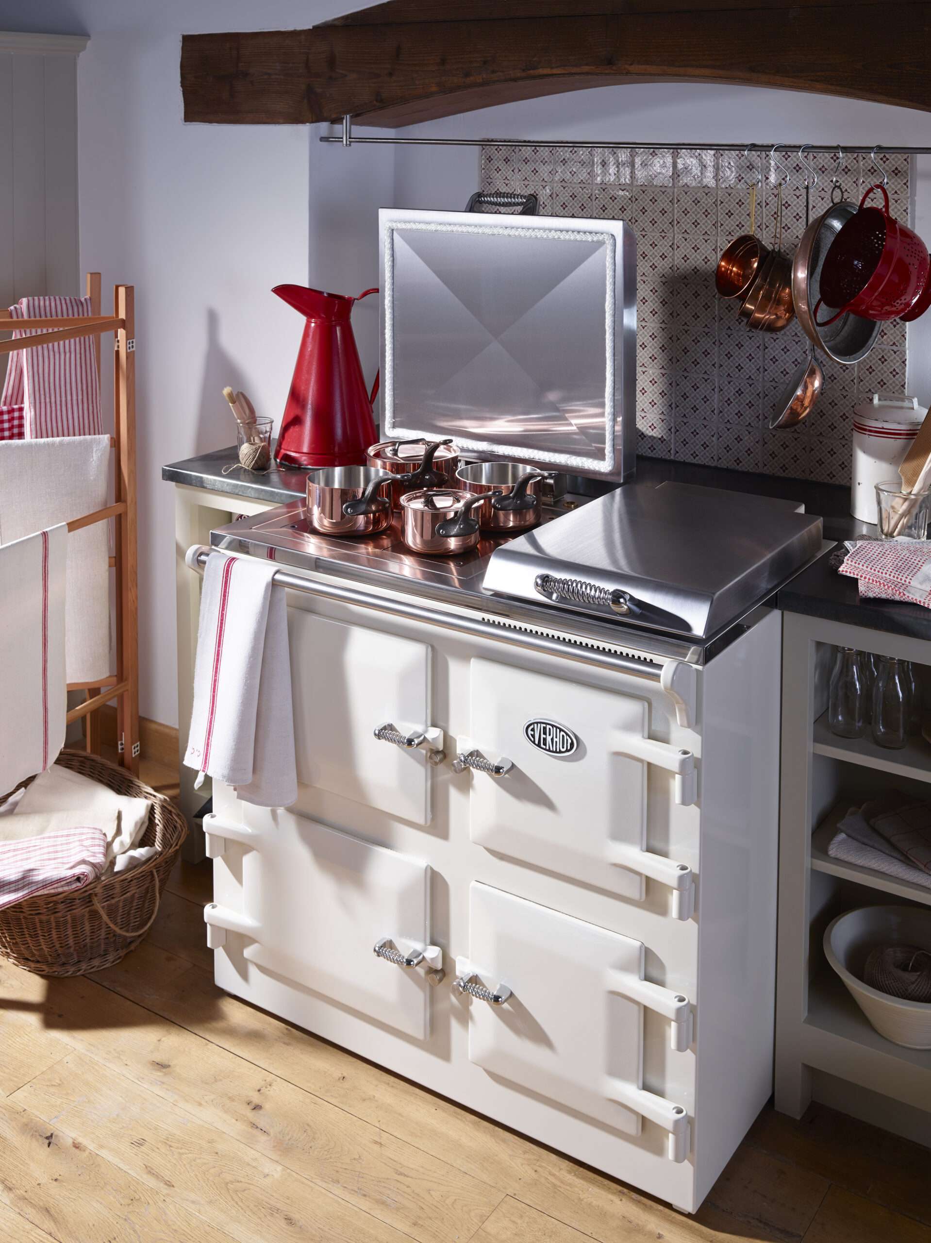 Cream coloured Everhot 100i range cooker with copper cookware on it.