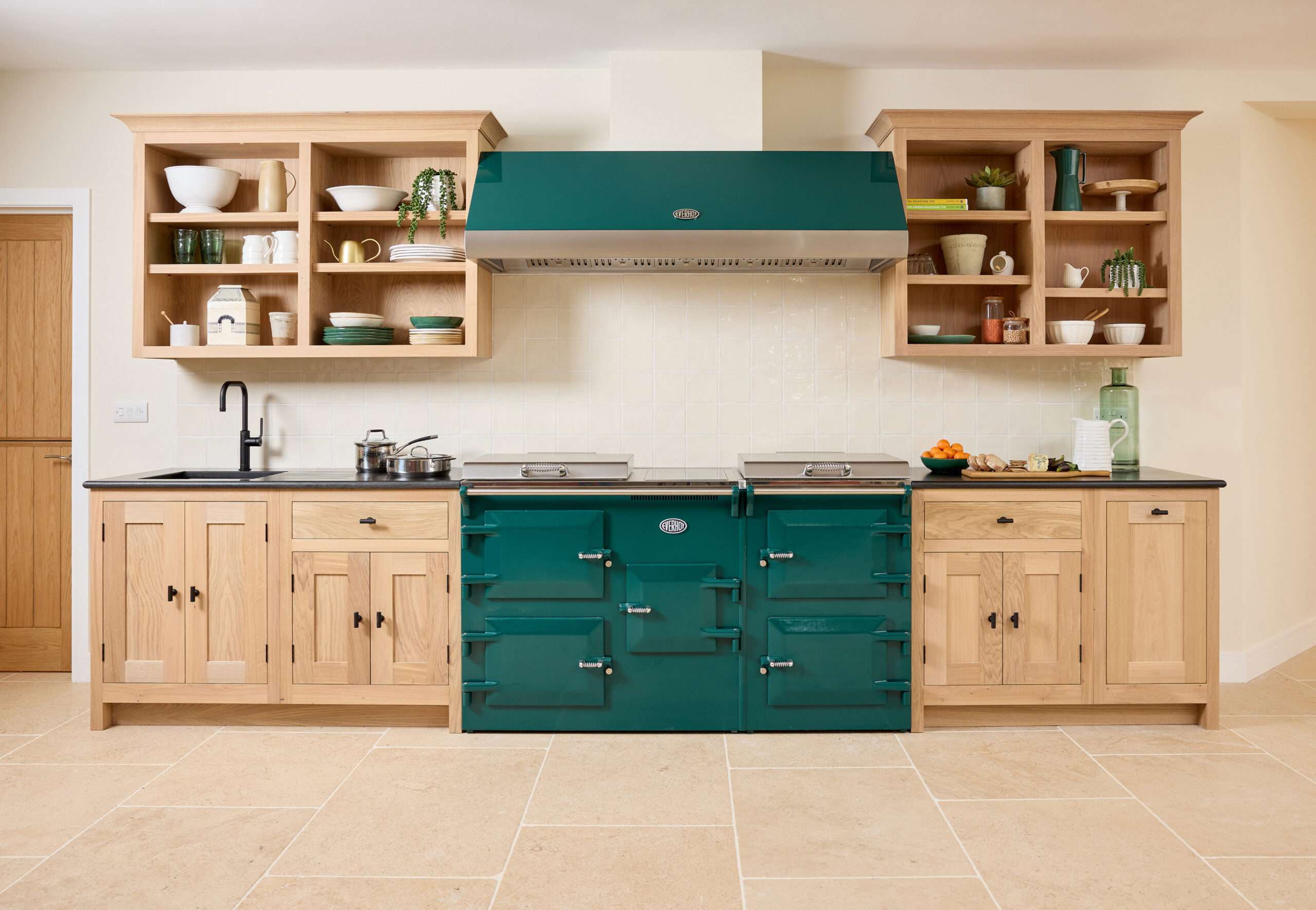 Forest green everhot range cooker installed in bare wood kitchen.