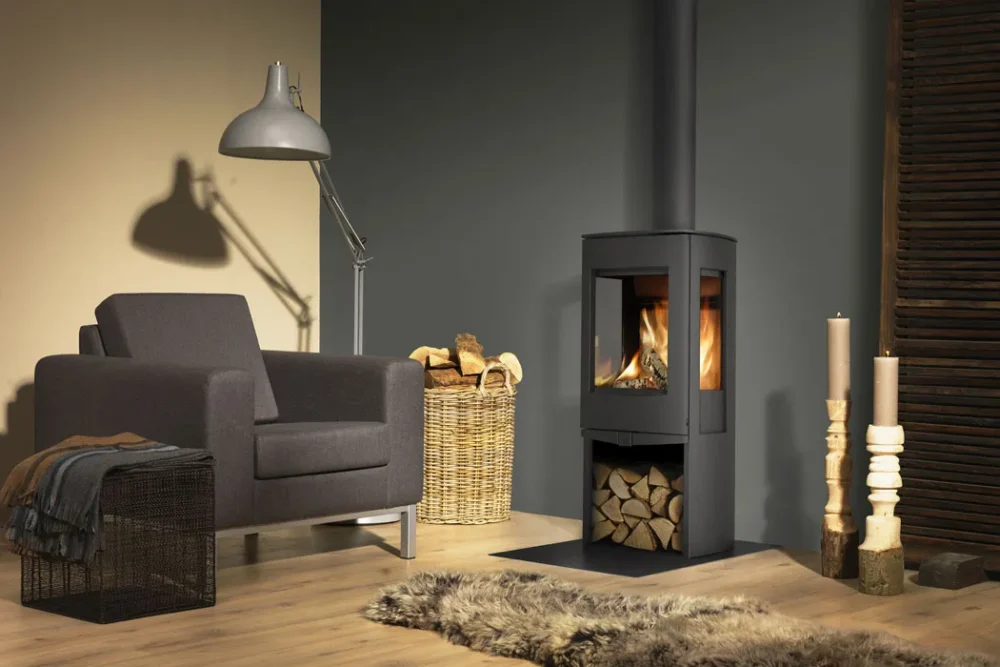 Dik Geurts Folke wood burner with firewood stacked beneath it.