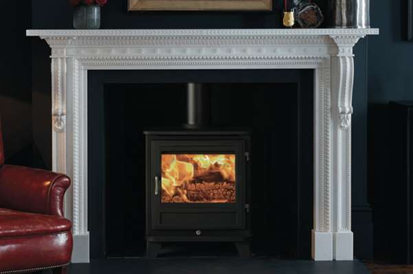 a chesney wood burning stove in a traditionally decorated living room