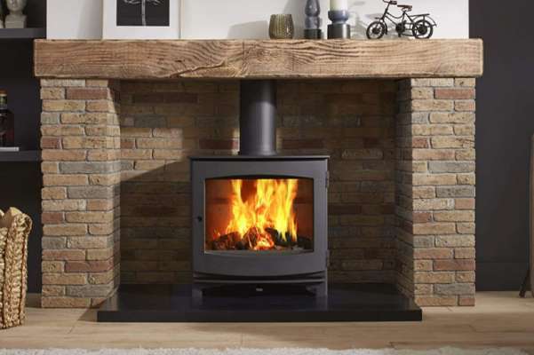 a dik geurts wood burning stove in a traditionally decorated living room